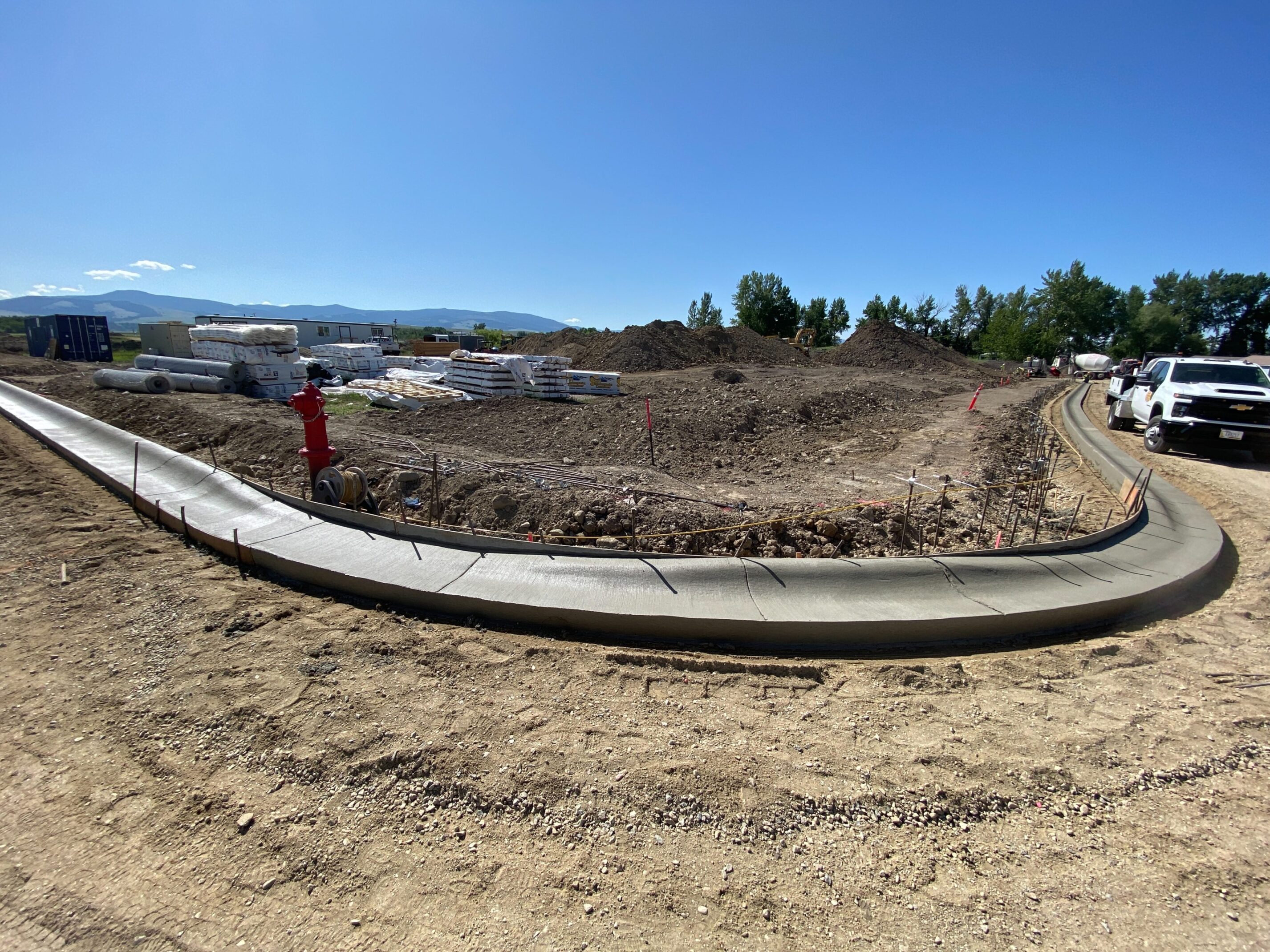 Freshly poured concrete sidewalk in construction area.
