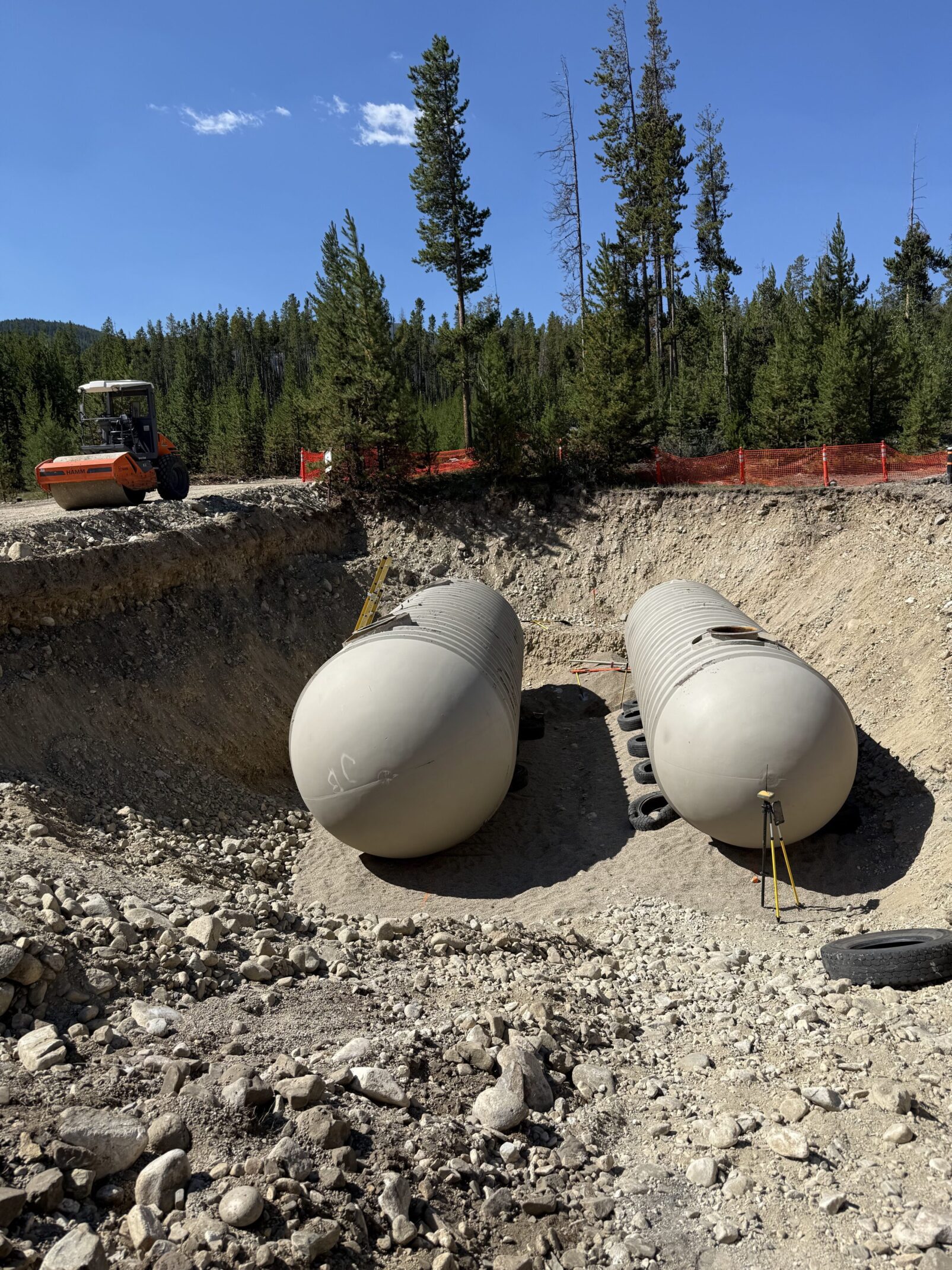 Two large tanks in a construction site.